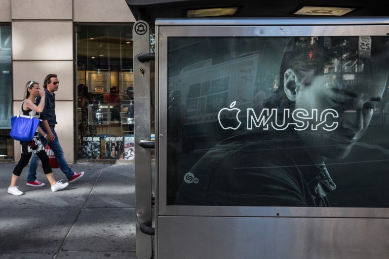 NEW YORK, NY - AUGUST 07:  An advertisement for Apple Music is posted on the streets of Manhattan on August 7, 2015 in New York City. After launching in June Apple announced it has attracted 11 million users during its trial period.  (Photo by Andrew Burton/Getty Images)